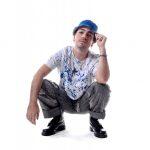 photograph of a man wearing a white t-shirt with blue paint-like pattern