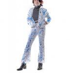 photograph of someone wearing a white jacket and paints with blue, paint-like splatters on them