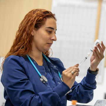 Female nurse filling a syringe
